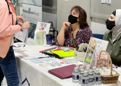 person visiting the loving arms care booth